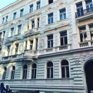 a large blue building with many windows on a street at Prague Centre Armani Apartment in Prague