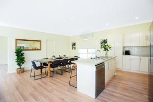 a kitchen with a table and chairs in a room at Aldinga Beach Experience - C21 SouthCoast Holidays in Aldinga Beach