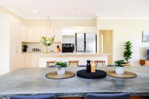 a kitchen with a large concrete table with plants on it at Aldinga Beach Experience - C21 SouthCoast Holidays in Aldinga Beach