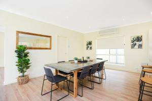 a dining room with a table and chairs at Aldinga Beach Experience - C21 SouthCoast Holidays in Aldinga Beach +26 photos