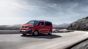 a red van is driving down a road at Hotel Grand Nefeli in Vasiliki