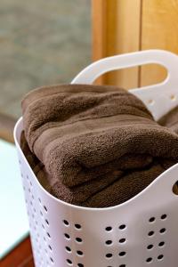 a laundry basket with a towel in it at Deluxe Room 130平米 URUMAHOTEL in Uruma