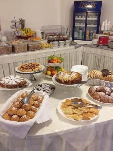 a buffet with many different types of pastries on a table at Hotel Arcobaleno in Celle Ligure