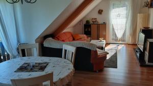 a living room with a couch and a table at Ferienwohnung Familie Kaufmann in Langenberg