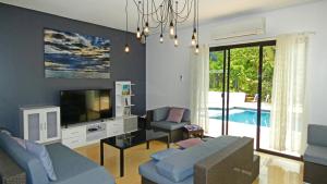 Μια τηλεόραση ή/και κέντρο ψυχαγωγίας στο Luxury Villa with Pool in Tropical Garden