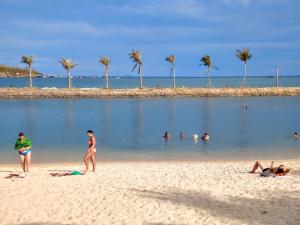 a group of people in the water at a beach at Seaside Villas An Vien Nha Trang in Nha Trang