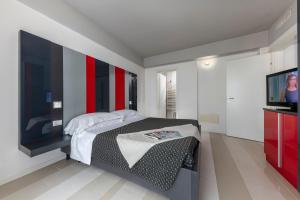 a bedroom with a bed and a flat screen tv at Residence Altomare in Riccione +55 photos