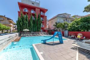a swimming pool with a slide in front of a building at Residence Altomare in Riccione