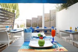 a table with a plate of food on top of it at Rivazzurra Design Rooms in San Vito lo Capo