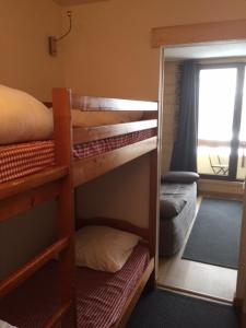 a room with bunk beds with a mirror and a window at LES CHATAIGNIERS GRIS in Isola 2000