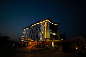 a large building with lights on it at night at Hotel JSR Continental in Dehradun