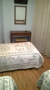 Postel nebo postele na pokoji v ubytování Hostal ** EC León