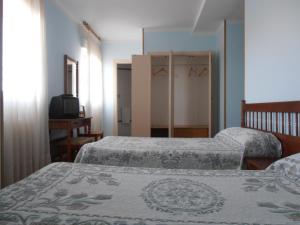 Postel nebo postele na pokoji v ubytování Hostal ** EC León