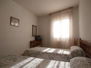 Postel nebo postele na pokoji v ubytování Hostal ** EC León