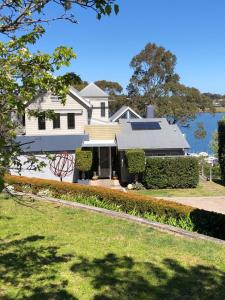 a white house with a solarium on it at The Point BnB in Paynesville