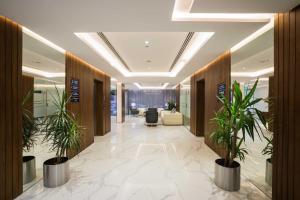 a hallway with potted plants in a lobby at Boudl Al Wadi in Riyadh
