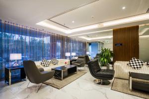 a lobby with couches and chairs and windows at Boudl Al Wadi in Riyadh