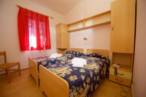 Ένα ή περισσότερα κρεβάτια σε δωμάτιο στο Villaggio Gargano