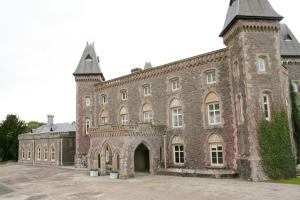 a large brick building with a tower on top at Llandeilo Farmhouse in Llandeilo