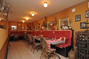 a restaurant with a table and chairs in a room at B&B de Valkenhorst in Lelystad