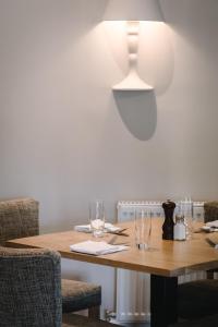 
a dining room table with two chairs and a lamp at The Glen Mhor Apartments in Inverness
