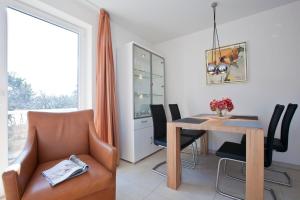a dining room with a table and chairs at Jann-Berghaus-Straße 29 in Norderney