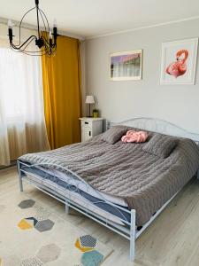 a bedroom with a large bed with a gray comforter at Amelie's House in Rajcza