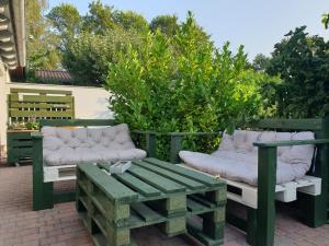 a patio with a bench and a table and chairs at Clara Hills in Eberswalde