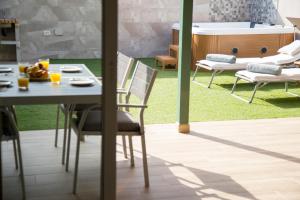 patio con mesa, sillas y bañera en Villa situada en Maspalomas Gran Canaria,, en Maspalomas
