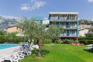 a villa with a swimming pool and a resort at Hotel Holiday Sport & Relax in Nago-Torbole
