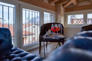 a living room with a table with two glasses of wine at Locanda delle Mercanzie in Brescia