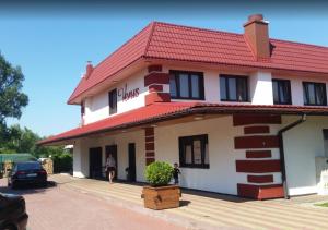 a large white building with a red roof at Restauracja Venus in Ostrowiec Świętokrzyski