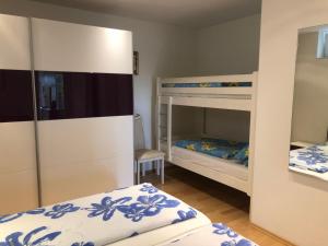 a bedroom with two bunk beds and a mirror at Idyllisches Wohnen Weinberg in Bad Kissingen +58 photos