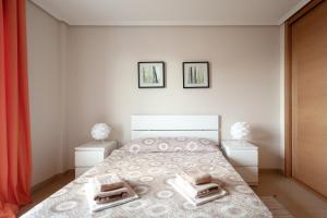 a bedroom with a large bed with two night stands at Apartamento Vista Roja La Tejita in Granadilla de Abona +24 photos