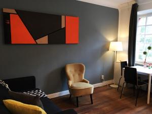 a living room with a chair and a table at The red house in Luxembourg