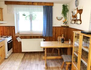 a kitchen with a table and a window at Horský dům Pernink in Pernink