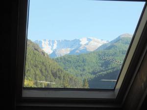 a window with a view of a mountain at appartamenti la ginestra in Cesana Torinese