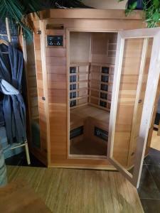 a large wooden cabinet with a glass door at Au clair de lune in Chavelot
