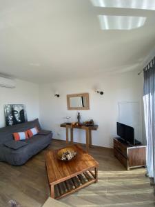 a living room with a couch and a table at Villa CAlisti in Belgodère