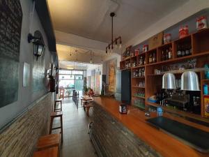 a kitchen with a bar and a large window at SevillaDream Hostel in Seville