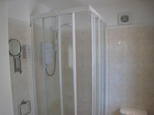 a shower with a glass door in a bathroom at Falstaff Cottage for up to 5, Stratford upon Avon in Stratford-upon-Avon