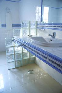 La salle de bains est pourvue d'un lavabo et d'un miroir. dans l'établissement LUXURY STYLE VILLA AURORA Roche, à Roche