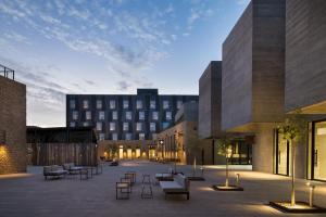 une cour avec des chaises et un bâtiment en arrière-plan dans l'établissement Keo Hotel - Ovalle Casino Resort, à Ovalle