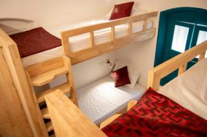 a small room with two bunk beds in it at Roambay in Mysore