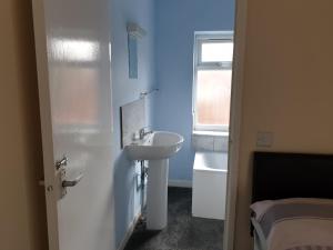 a small bathroom with a sink and a mirror at Tower House Hotel in Reading