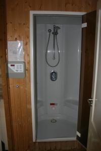 a shower stall in a bathroom with a shower at Vakantiewoning "De Kei" in Warns