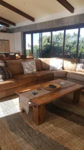 a living room with a couch and a coffee table at 91 Da Gama Beach House in Cape St Francis