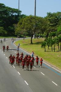 a group of people on horses running down a road at Hotel Regina Rio de Janeiro in Rio de Janeiro