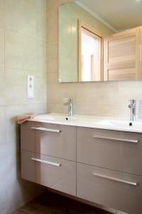 a bathroom with a sink and a mirror at Green Buda Valley: Holiday home with garden in Budapest