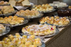 a buffet of pies and pastries on a table at Hotel Regina Rio de Janeiro in Rio de Janeiro